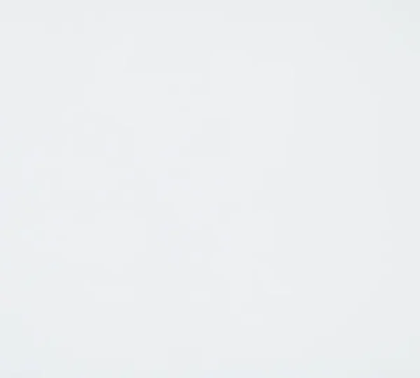 A calm, modern startup workspace with an empty meeting room in the background and a single focused worker in the foreground, suggesting fewer meetings and more deep work.