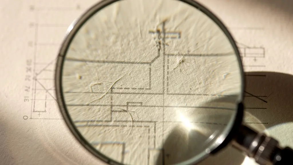 Close-up macro photography of a magnifying glass hovering over abstract paper textures, symbolizing the scrutiny of financial details.